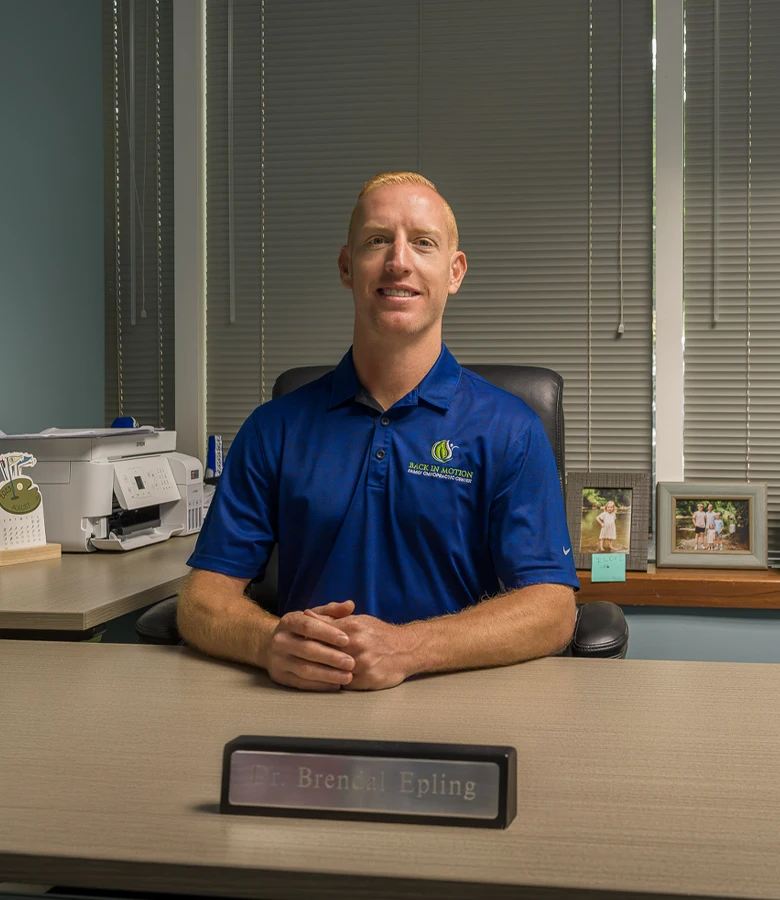 Brendal Epling Sitting at His Desk with his Name Tag in Front of Him